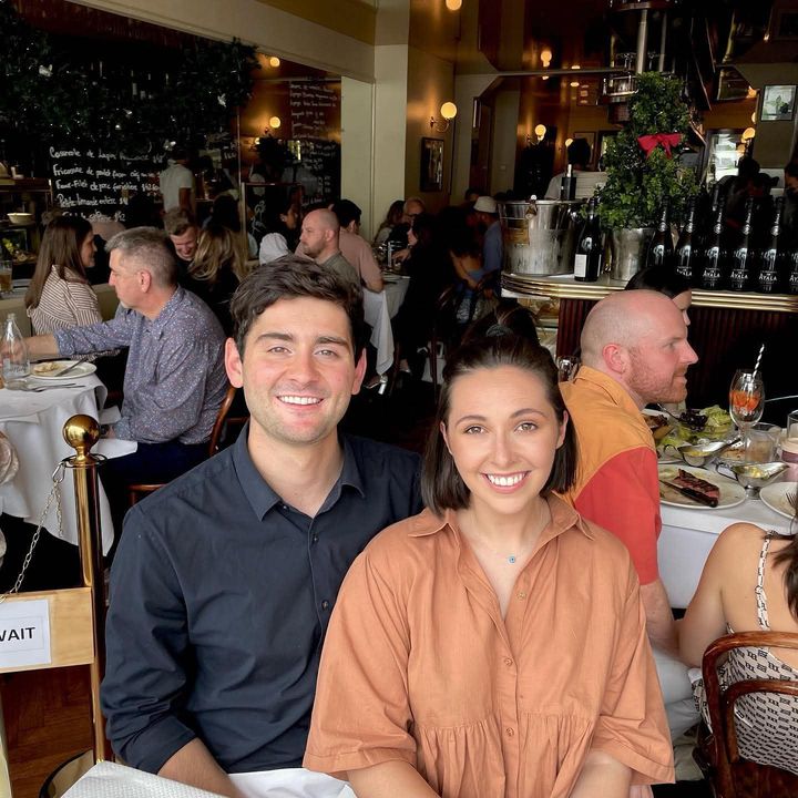Hayden and Phoebe smiling at a restaurant table